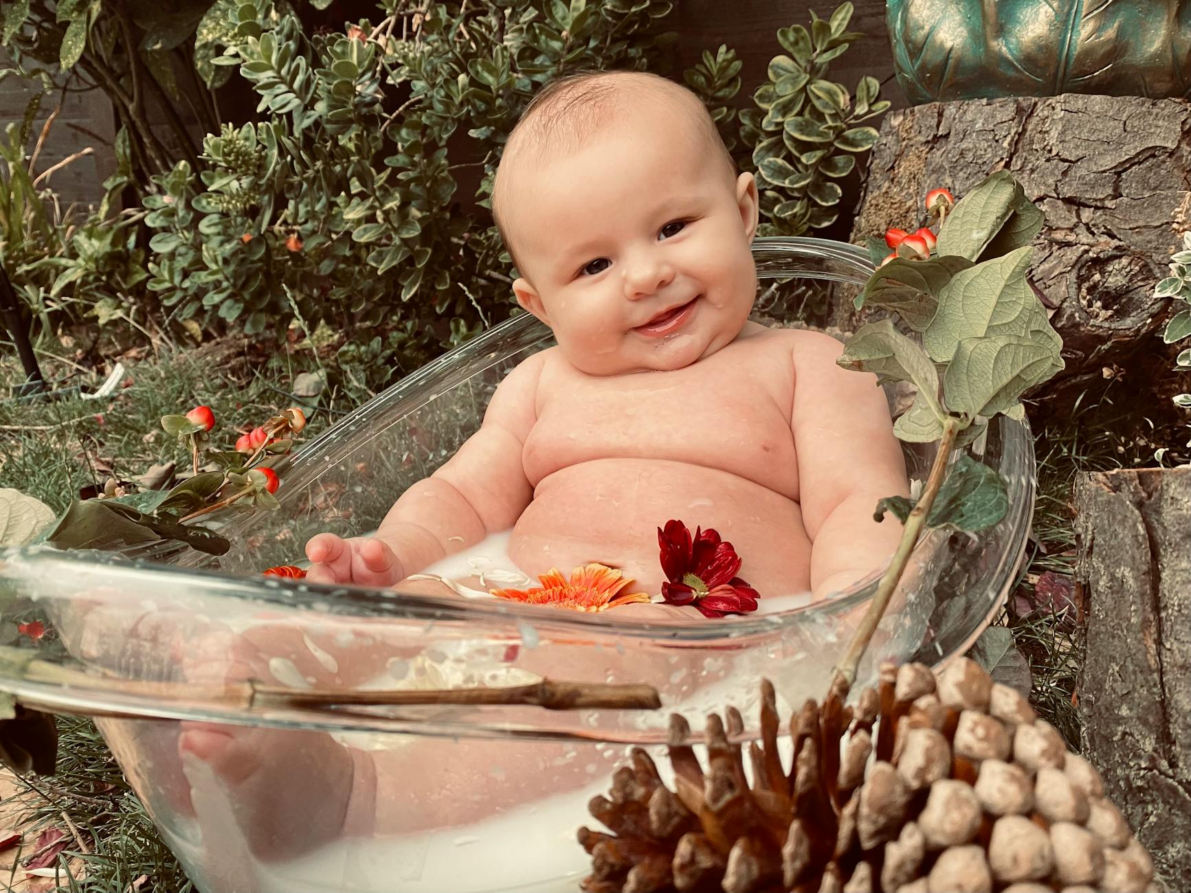 a baby in bathtub with flowers
