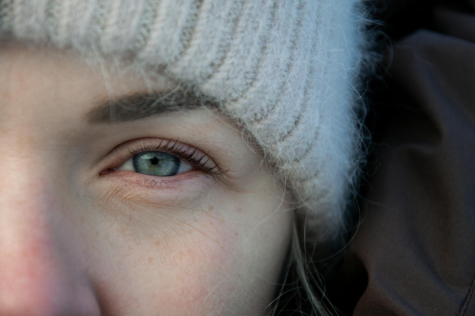 close up of a woman wearing a winter hat