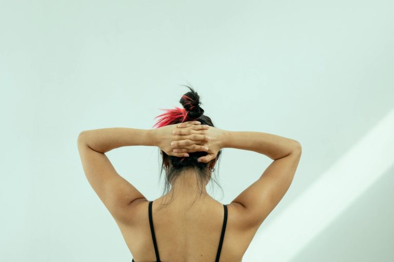 woman touching the back of her head